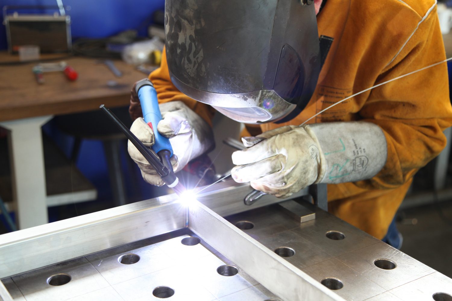 welder working on metal fabrication project